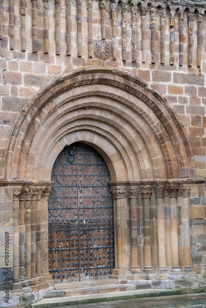 Fototapeta premium Royal monastery of Santa María de Veruela, 12th century Cistercian abbey, Romanesque façade around a splayed semicircular door, door of the abbey church , Vera de Moncayo, Zaragoza province, Spain