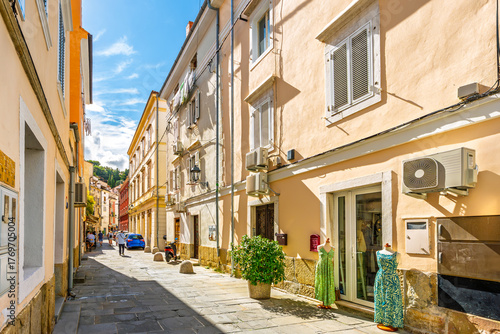 A picturesque street of colorful buildings in the historic old town of shops and cafes in the seaside town of Piran, Slovenia, on the Istrian coast of the Adriatic Sea.