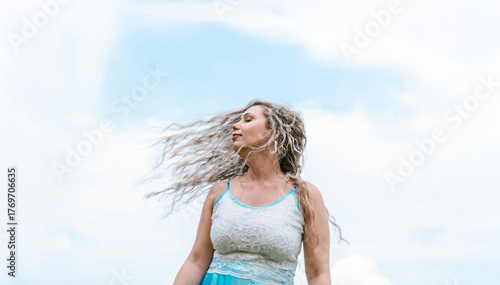 фотографія A serene half-length portrait of a woman in a white dress touched with blue, her