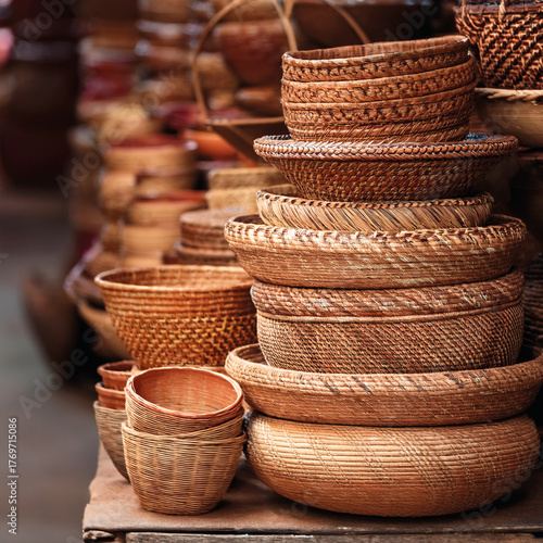 Stack of handwoven wicker baskets in earth tones, in an Indian market