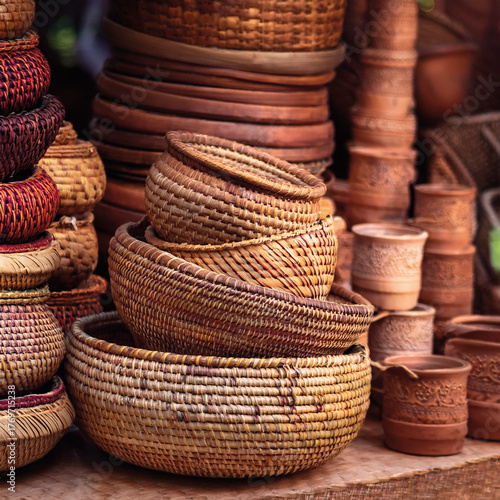 Stack of handwoven wicker baskets in earth tones, in an Indian market
