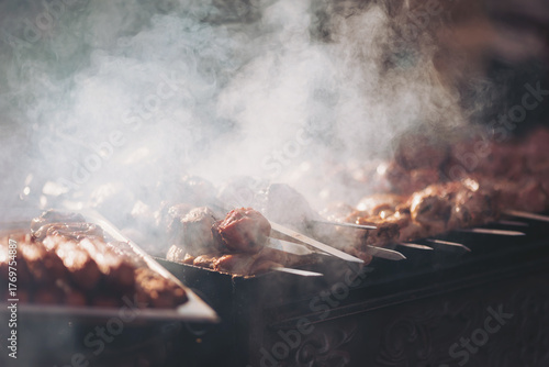 Tapeta Sizzling skewers and flavorful smoke at an outdoor barbecue gathering during a w