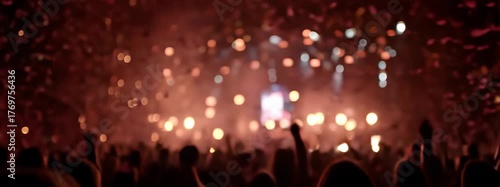 Excited Audience With Hands Raised at Colorful Concert with Confetti Falling and Stage Lights in the Background