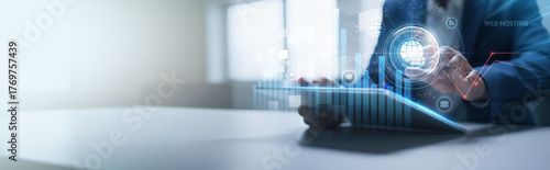 Businessman analyzing structured graph charts and tablet data of web hosting, cloud servers, domain management, website performance, network uptime, and data storage.