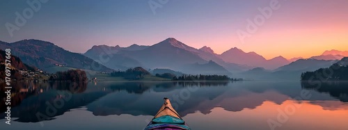 Colorful Kayak on a Calm Lake at Sunset Surrounded by Majestic Mountains