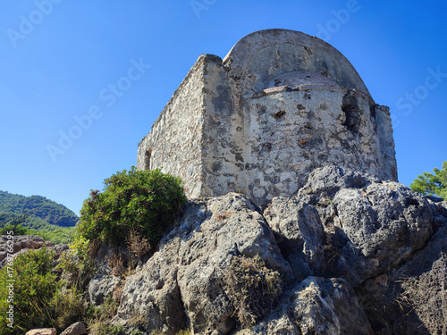 Low angle view of an ancient shrine on a rocky plateau in the ghost town of Kayaköy