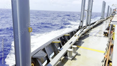 Cargo ship sailing in ocean with strong wind and waves crashing against hull — dynamic maritime scene showing the power of the sea and the resilience of ocean-going vessels in fresh wind conditions 21
