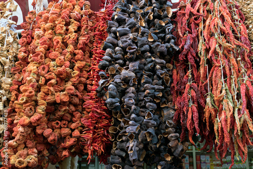 Dried vegetables hanging in a local market. Dried eggplant and red pepper