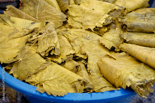 Brined grape leaves prepared for stuffed dishes in the market.