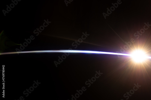 Lens Flare. Light over black background. Easy to add overlay or screen filter over photos. Abstract sun burst with digital lens flare background. Gleams rounded and hexagonal shapes, rainbow halo.