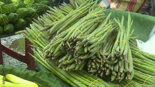 Fresh drumstick vegetables arranged in a local market