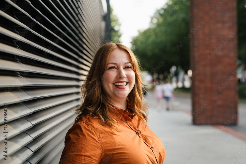 Fototapeta premium Plus size woman standing outdoors in the city.