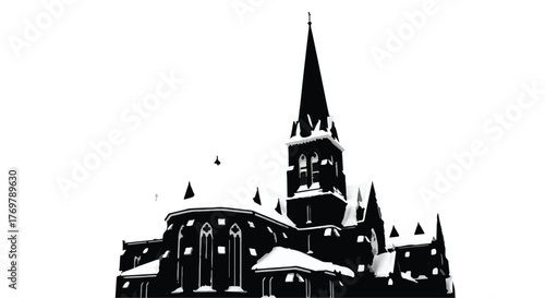 Majestic church steeple covered in winter snow, silhouetted against a bright sky.