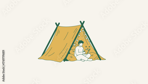 Person enjoying solitude by writing in a journal, sitting comfortably on pillows inside an indoor tent decorated with string lights, symbolizing relaxation and personal reflection