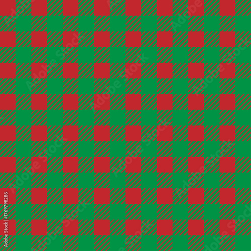 Seamless plaid pattern in classic Christmas colors of red and green. Tartan, check, or gingham background.