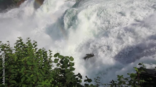 The majestic Rhine Falls, Europe's largest waterfall, with its powerful flow and a rainbow visible through the spray, near the towns of Neuhausen am Rheinfall and Laufen-Uhwiesen