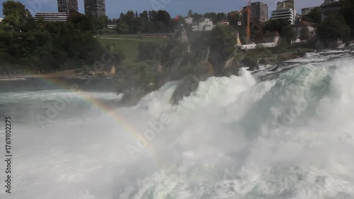 The majestic Rhine Falls, Europe's largest waterfall, with its powerful flow and a rainbow visible through the spray, near the towns of Neuhausen am Rheinfall and Laufen-Uhwiesen