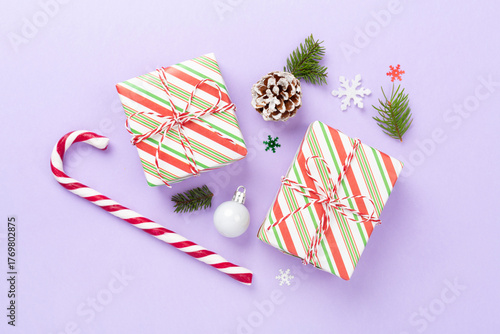 Striped Christmas gift boxes on color background, top view