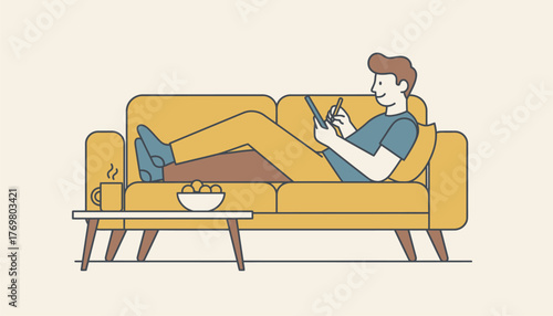 Man lying comfortably on a yellow sofa in a cozy home environment, using a digital tablet with a stylus, representing leisure, online activities, and modern lifestyle