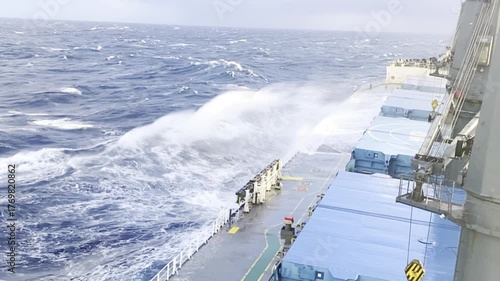 Cargo ship battles heavy storm in the North Atlantic — huge waves, strong wind, and sea spray show human resilience. Editorial / Documentary /  dramatic maritime scene 