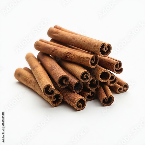 Close-up photograph of a neat pile of cinnamon sticks on white background.