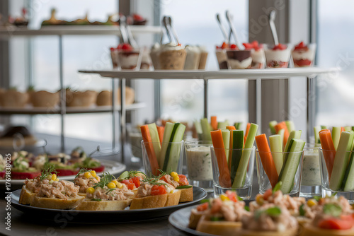 Catering buffet table with assorted appetizers canapes and vegetable cups