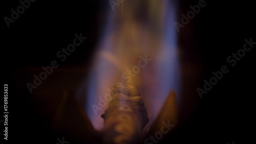 Natural gas boiler's flame is a bright mix of orange and blue. It burns steadily and strongly, providing efficient heating with its vibrant glow in the darkness