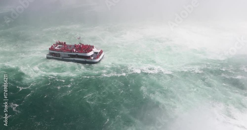 Wallpaper Mural A Canadian tour boat packed with visitors in red ponchos pulls away from the base of Horseshoe Falls, surrounded by violent teal water and thick white mist. Human thrill against overwhelming power. Torontodigital.ca