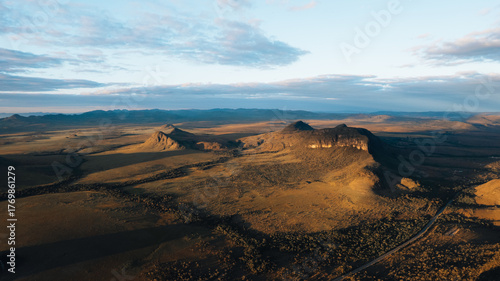 aerial drone Chapada dos Veadeiros view, mountains, green fields with buritis, Morro da Baleia, Alto Paraiso de Goias at golden hour sunset