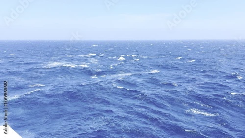 Cargo ship sailing in ocean with strong wind and waves crashing against hull — dynamic maritime scene showing the power of the sea and the resilience of ocean-going vessels 2