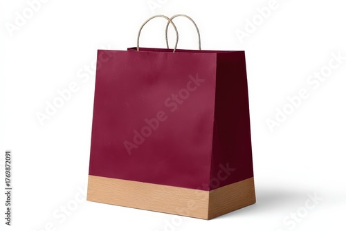 A deep burgundy paper shopping bag with a light beige bottom border and simple handles sits elegantly on a white background.