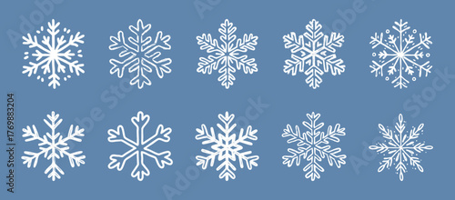 Hand-Drawn Grunge Snowflake Set on Blue Background. Sketch collection of ten unique white snowflakes with a hand-drawn grunge style on blue. Ideal for winter, holiday, or festive. Vector graphic set