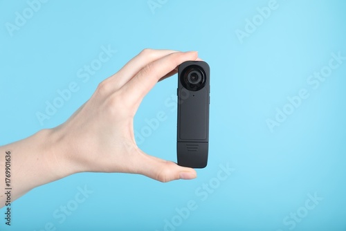 Wallpaper Mural Woman with hidden spy camera on light blue background, closeup Torontodigital.ca