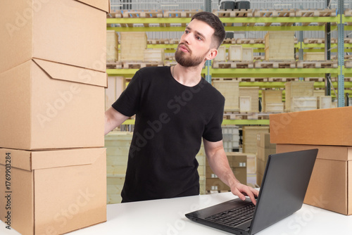 Man in warehouse checks sta...
