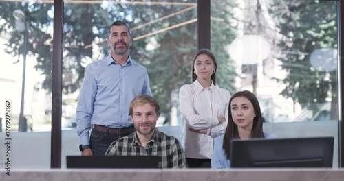 Business Team of Four Celebrates Success in Modern Office