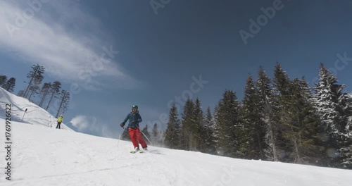 Enjoying powder skiing on sunlit slopes with panoramic mountain views in winter wonderland