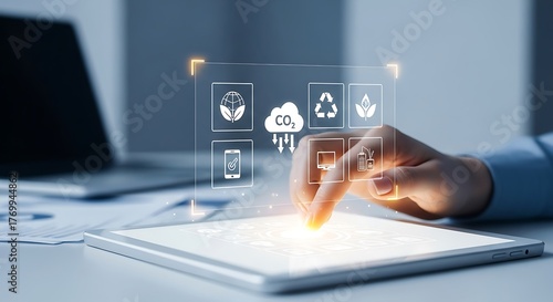 A persons finger touches a tablet screen displaying icons related to environmental protection and sustainable energy sources
