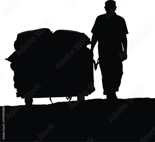 Silhouette of Man Pulling Heavy Cart, Concept of Hard Labor, Struggle, and Manual Work