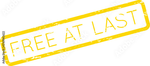 A vibrant yellow rectangular stamp with text proclaiming FREE AT LAST for liberation and triumph