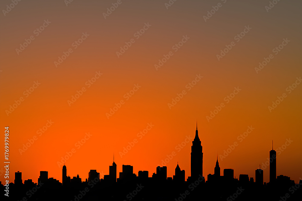 Fototapeta premium City Skyline Silhouette at Sunset with Vibrant Orange Sky, Urban Horizon Background, Copy Space