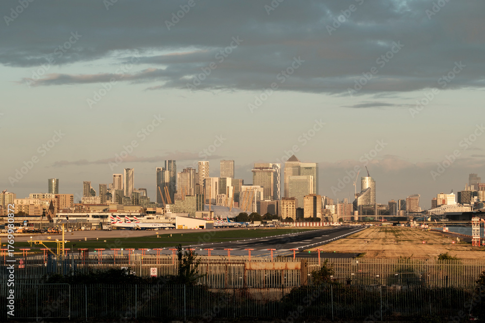 Fototapeta premium London city airport with canary wharf cityscape at sunset