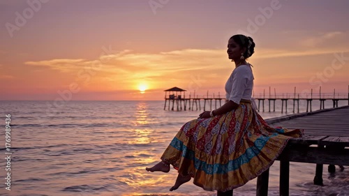 Indian Woman in colorful skirt sitting on pier at sunset by the sea, evoking peace, reflection, and natural beauty