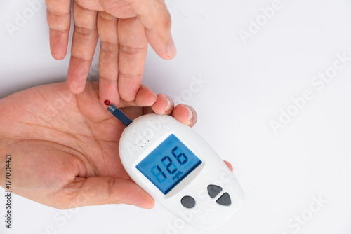 Woman's hands checking diabetes and hyperglycemia with digital blood sugar meter. Healthcare and medical concept	