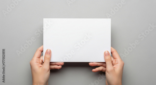 Hands Holding Blank White Card on Gray Background, Minimal Design for Copy Space