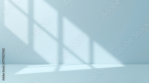 Minimal abstract light blue background with soft natural light and window shadows on a plaster wall. Clean modern composition ideal for product presentation, mockup design, or minimalist branding  