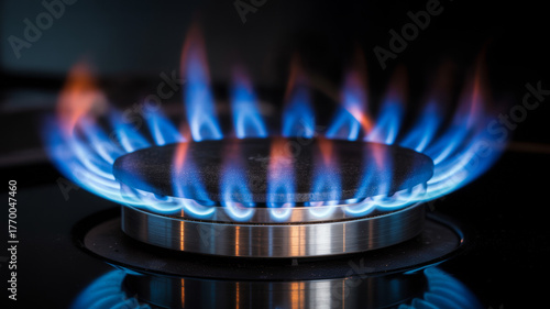Vibrant blue flames dance on modern gas stove burner ablaze
