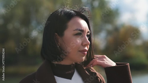 serene lakeside portrait, serene outdoor image capturing reflective woman beside calm lake ambiance