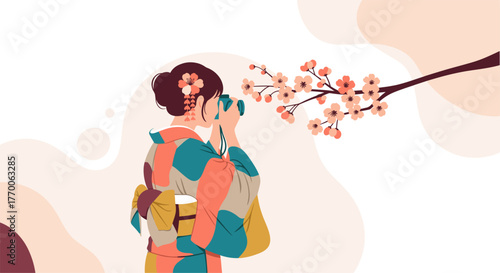 A woman in a traditional kimono photographs cherry blossoms in bloom, capturing the beauty of spring with a camera.