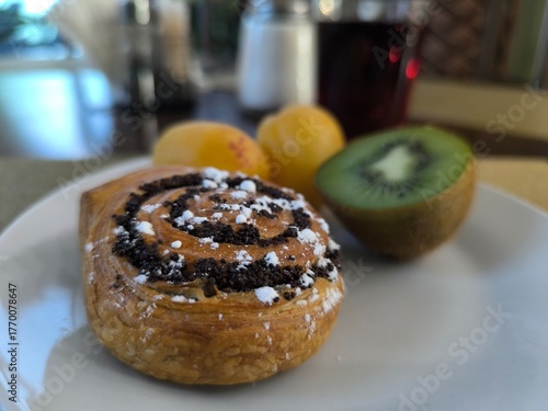 morning breakfast bun kiwi and apricots on white plate. Healthy eating concept