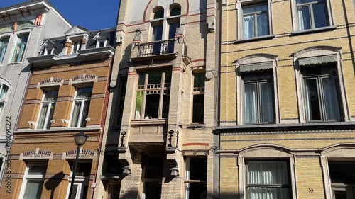 Row of charming, historic European townhouses with varied brick facades and architectural details in Antwerp, Belgium